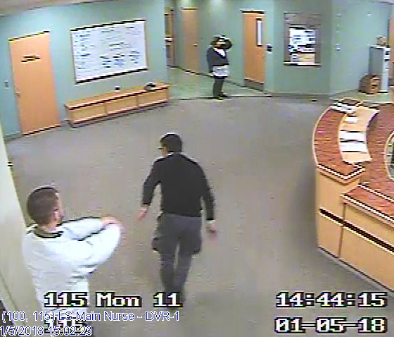 This still shot from surveillance video was a courtroom exhibit in the case and shows Najad, center, being shoved by a patient, in white, left.